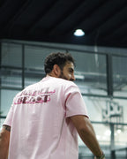 Padel Beast Arabic English pink tee worn on court, back print