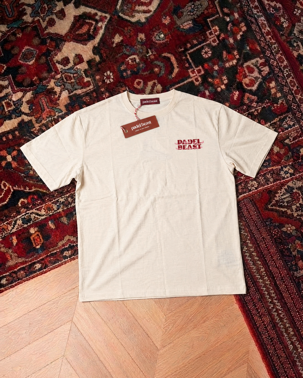Padel Beast bilingual Arabic cream tee front, new neck label and hangtag