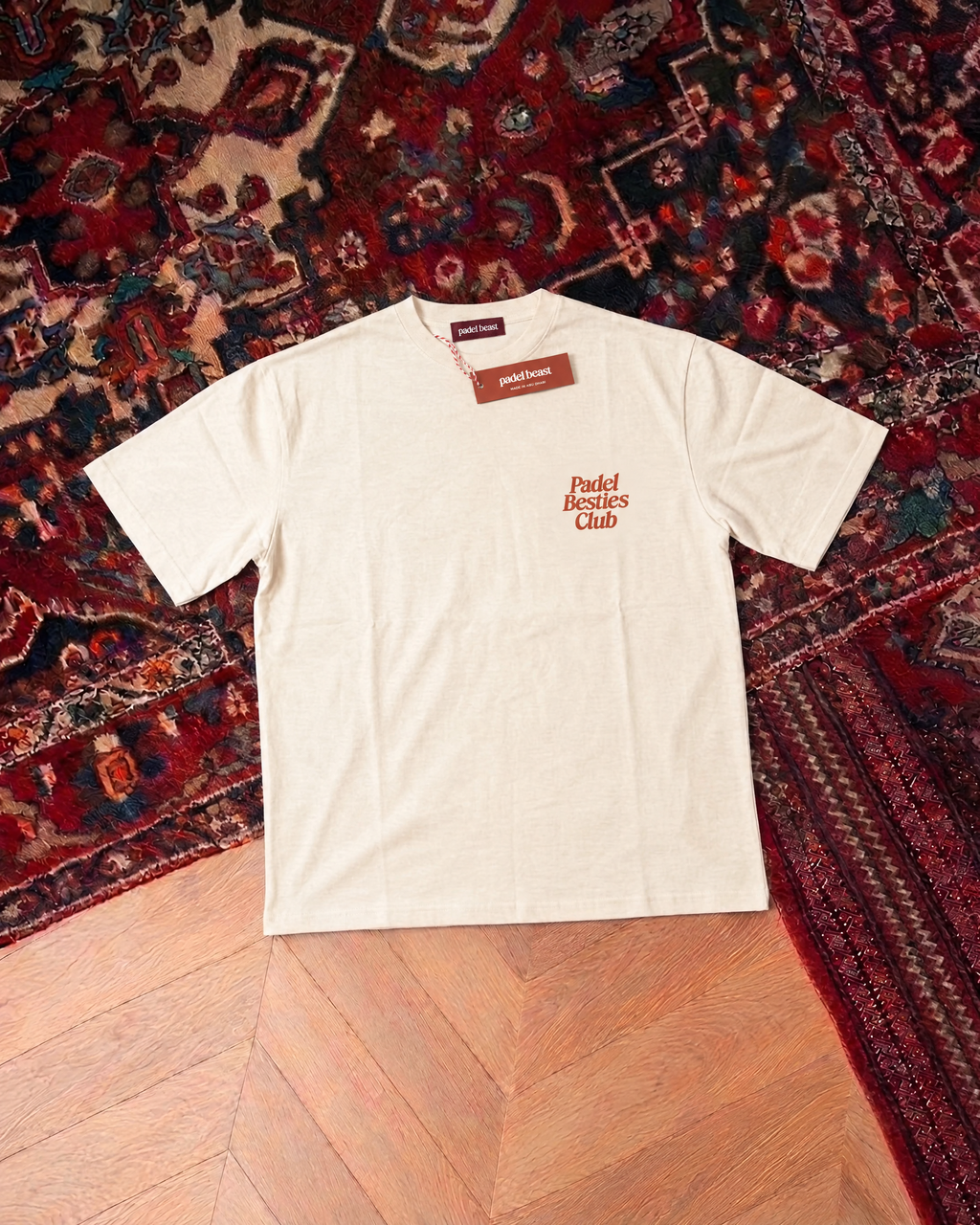 Padel Besties Club cream tee front, new neck label and hangtag