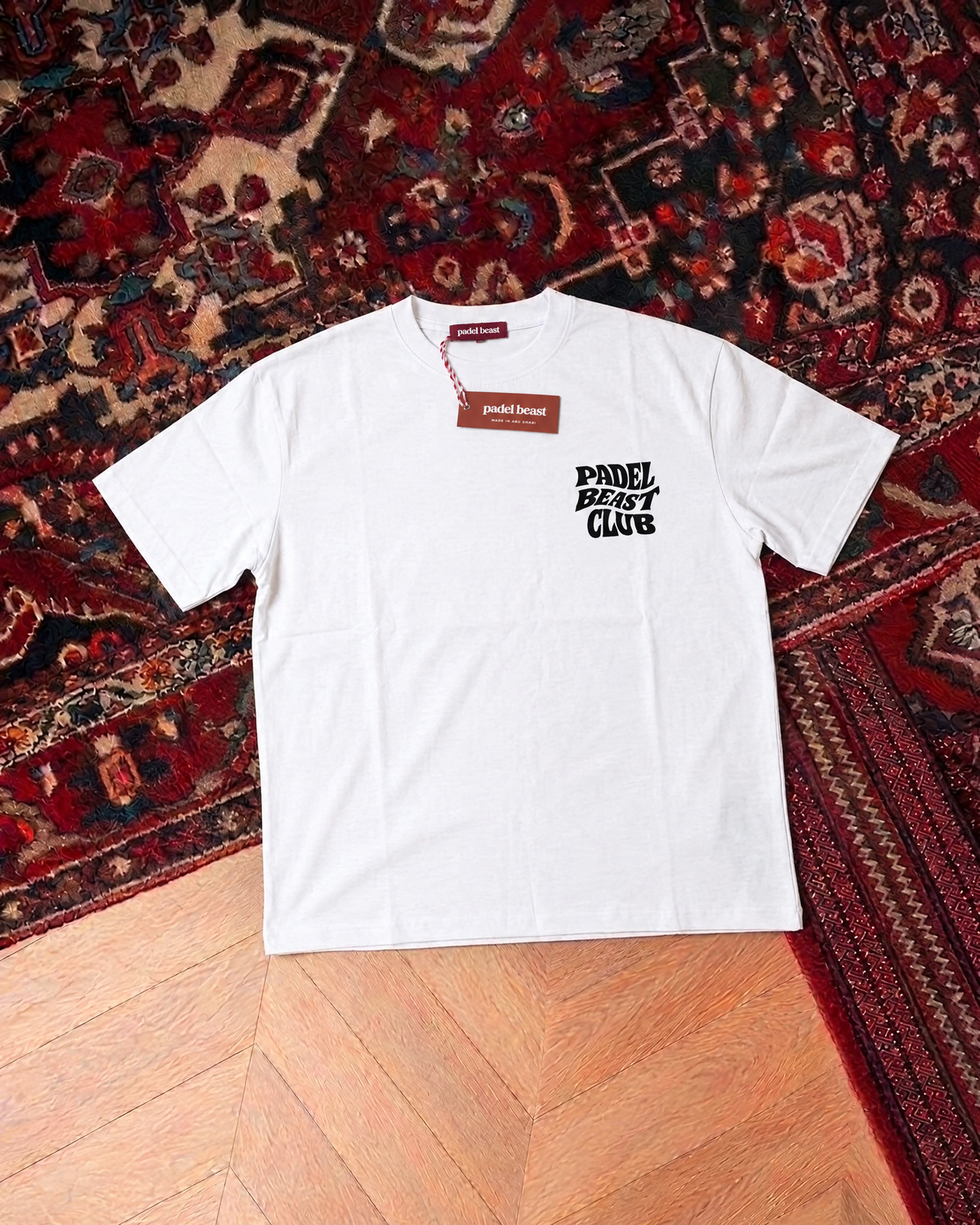 Padel Beast Club white tee front, new neck label and hangtag