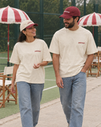 Couple wearing the Padel stole all my money cream tee