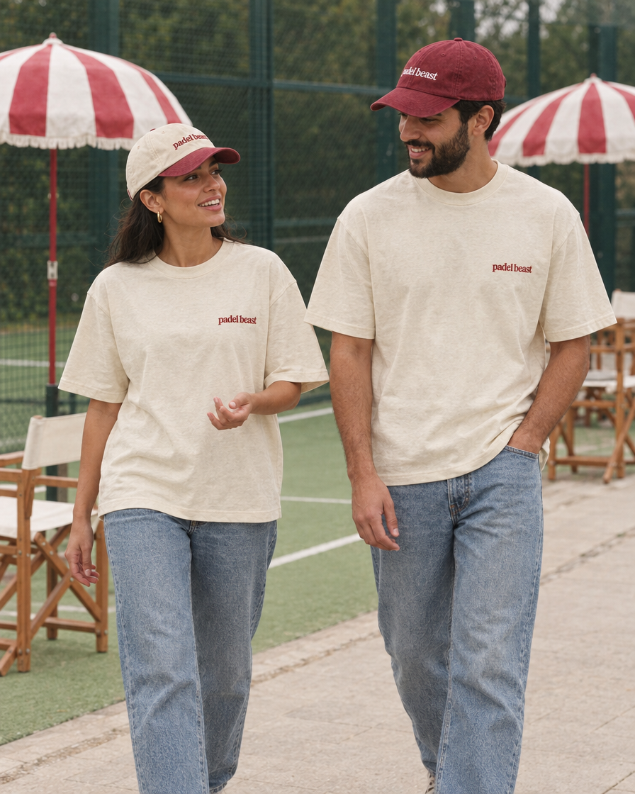 Couple wearing the Padel stole all my money cream tee