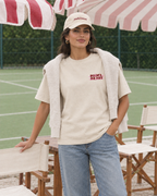 Padel Beast Arabic cream tee on a woman, front