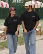 Couple wearing the Padel stole all my money black tee