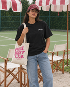 Padel stole all my money black tee on a woman, front, with tote bag